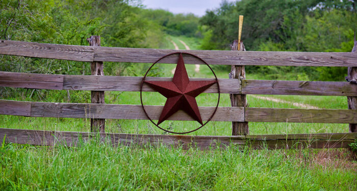 iron star in circle on wooden fence