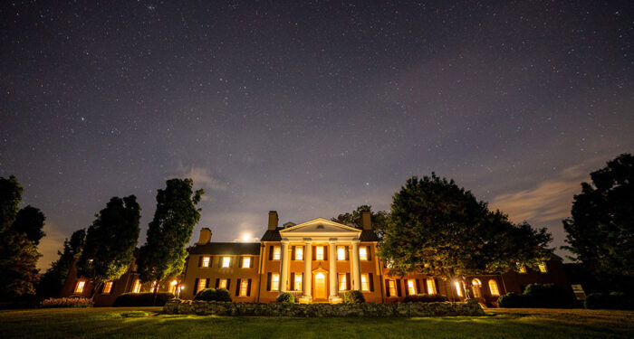 Manor house lit up at night