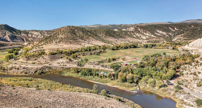 property view with river, meadow, and hills