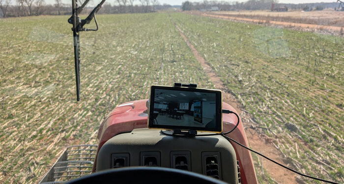 photo live streaming an auction while driving tractor