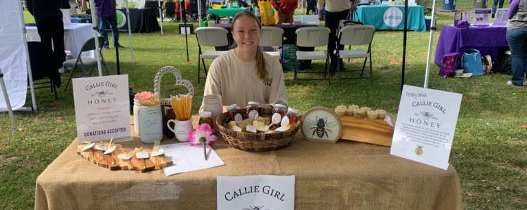 Author at a show selling her honey products