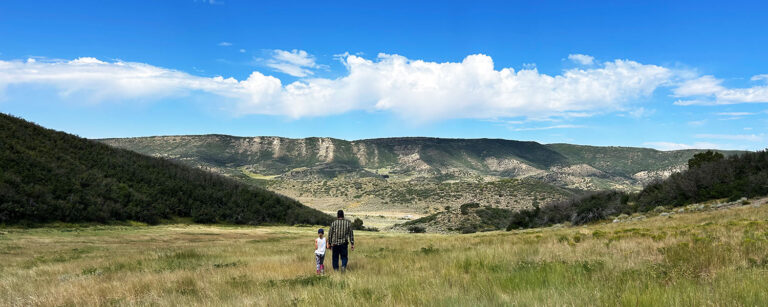 father and daughter looking out to distant plateau