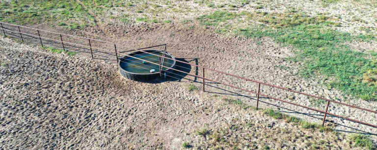water tank set up under pivot on rotational grazing fenceline