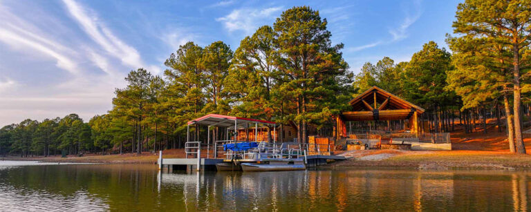 glassy lake with boat dock and trees