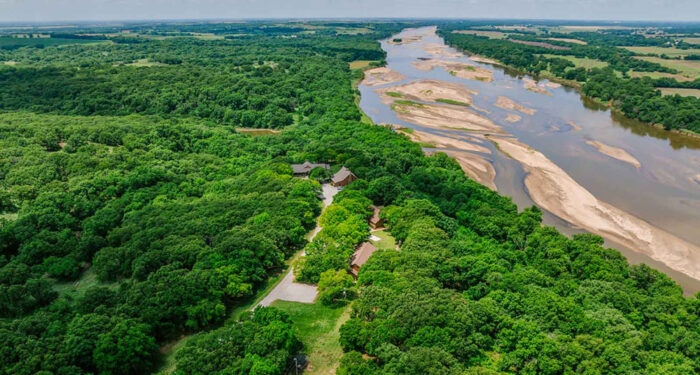 overview of home surrounded by trees along the Arkansas River in OK