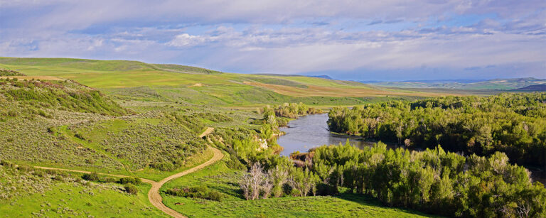 green mountain pasture with river